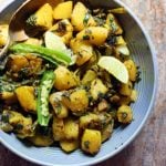 aloo palak served in a grey ceramic bowl.