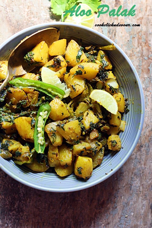 aloo palak served in a grey ceramic bowl.