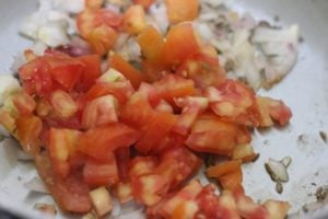 chopped tomatoes added to fried onions