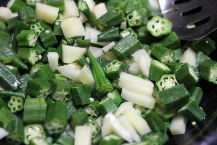 sauteing okra and potatoes for okra rice