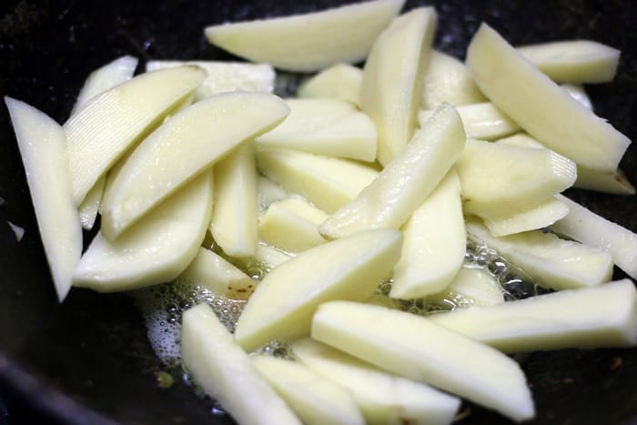 Adding potato wedges in hot oil