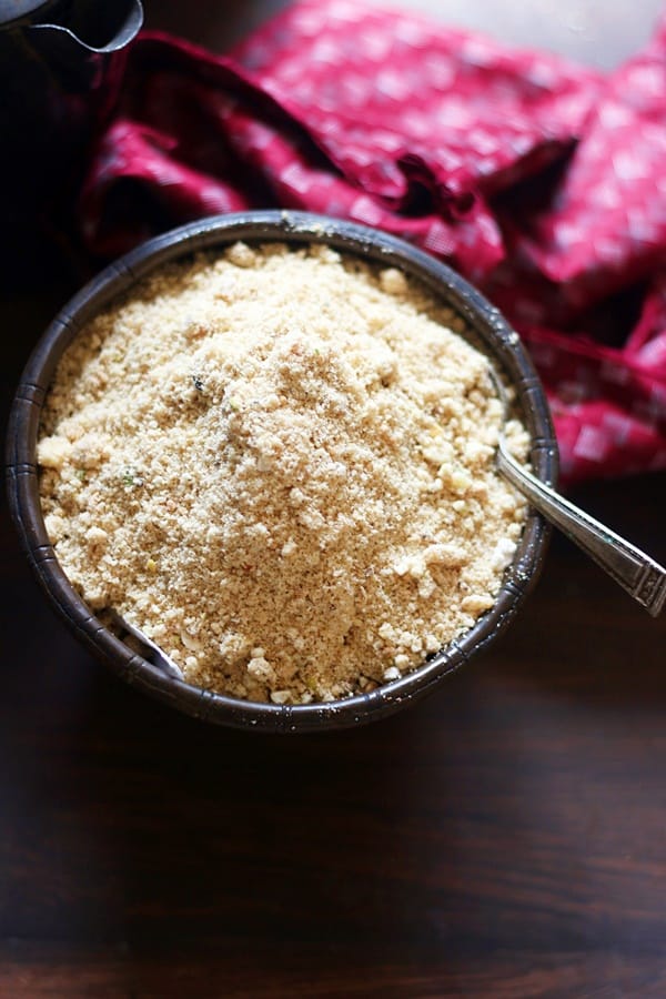 Winter special delicacy Punjabi panjiri served in a antique copper bowl with a spoon.