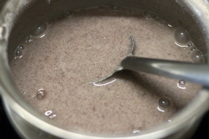 cooking ragi flour for making ragi malt