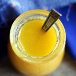 Homemade ghee in a small glass jar with a spoon