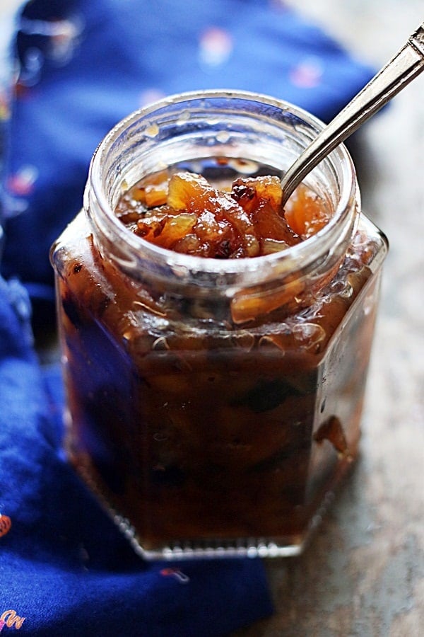 Pineapple chutney in a glass bottle with a soon