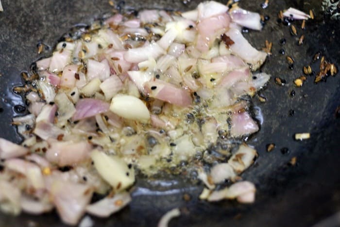 sautéing finely chopped onions mustard oil for achari paneer.