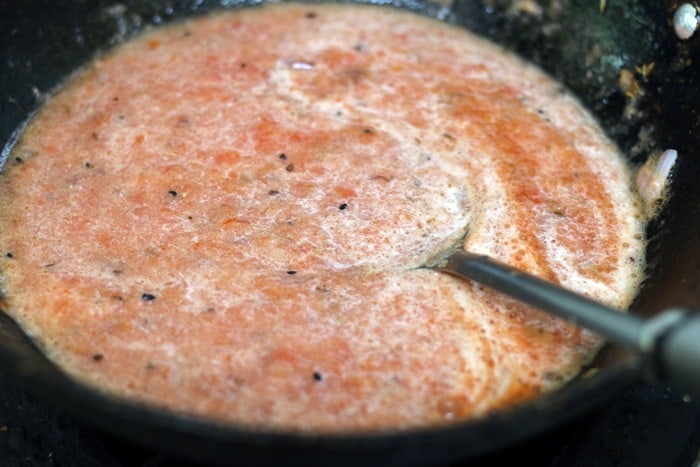 tomato puree added to sautéed onions