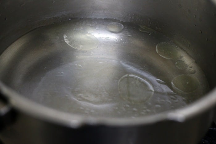 boiling water with few drops of oil and salt