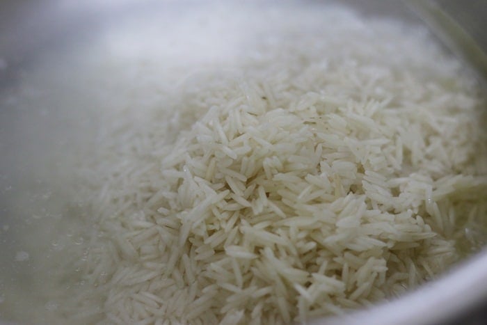 soaked and drained basmati rice added to boiling water