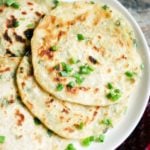 crispy flaky scallion pancakes in a white ceramic plate