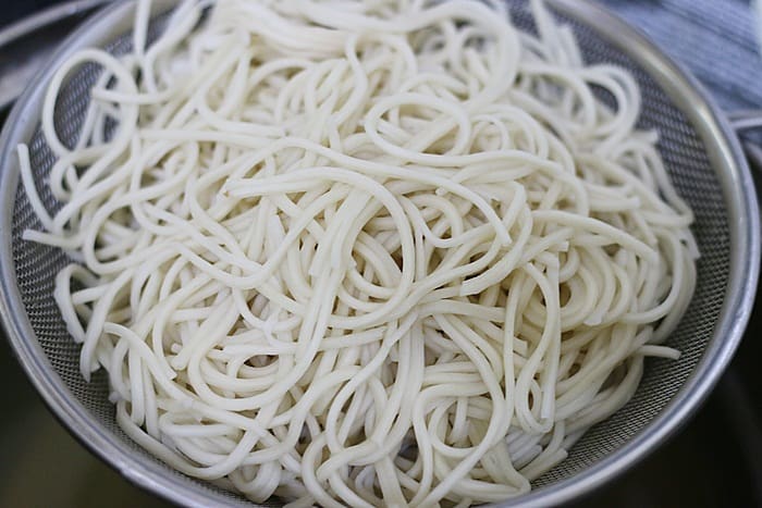 Cooked and drained boiled noodles for making schezwan noodles recipe