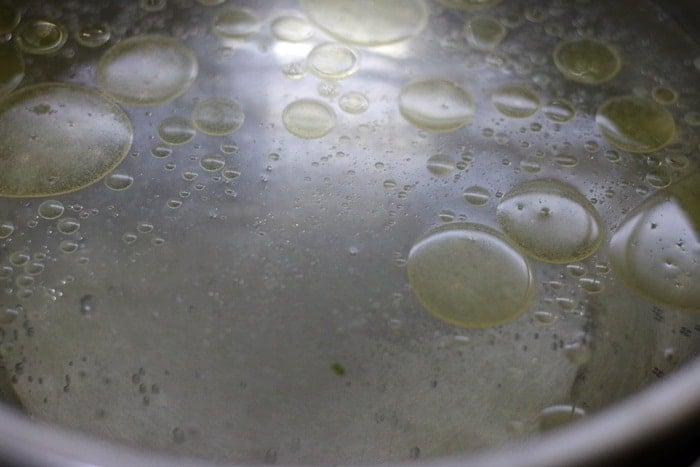 boiling water with few drops of oil and salt
