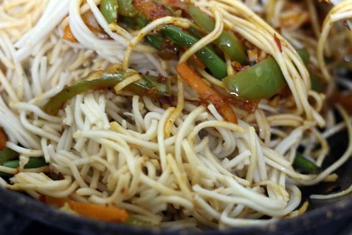 Tossing noodles with stir fried vegetables