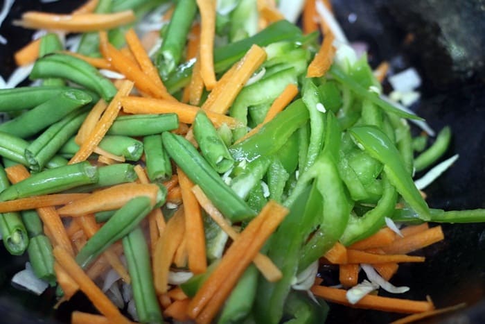 Vegetables added to sautéed onions