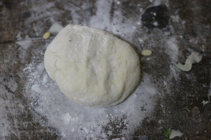 Rolling out portions of leavened dough
