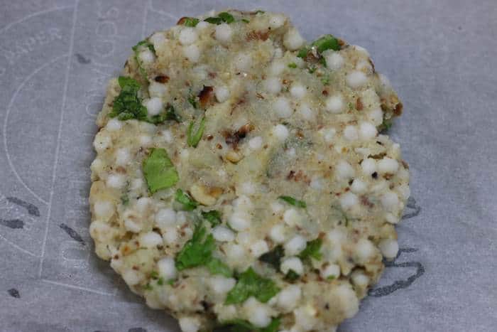 shaped sabudana thalipeeth on a parchment sheet