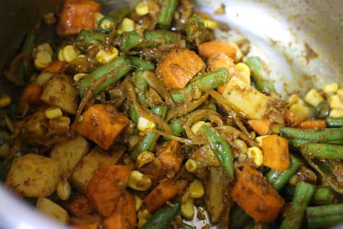 sauteing veggies in curry paste