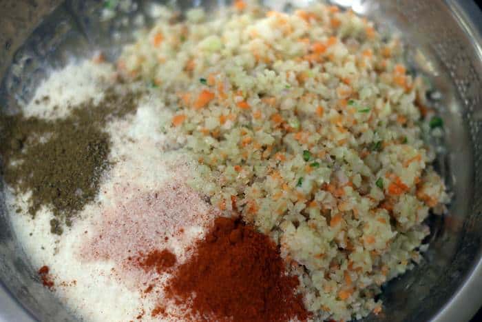 spice powder and rice flour added to minced vegetables
