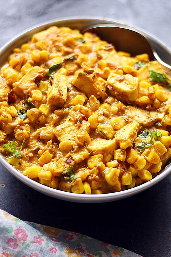 easy corn tofu curry in a grey bowl with a spoon