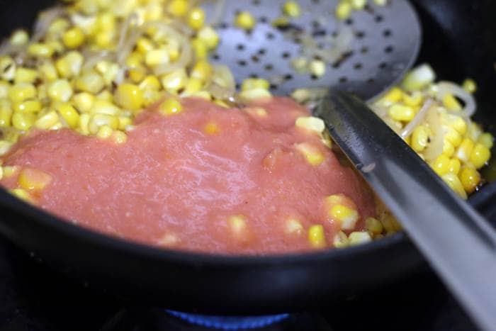 tomato puree added to sauteed corn
