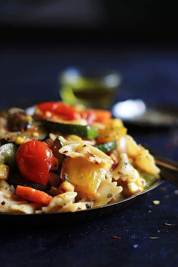 vegetables loaded vegan pasta salad served in a metal plate