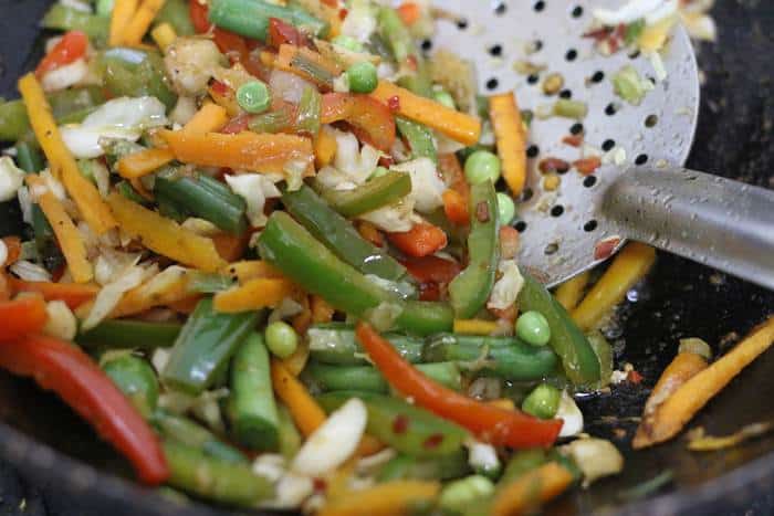 sauteing vegetables for thai fried rice