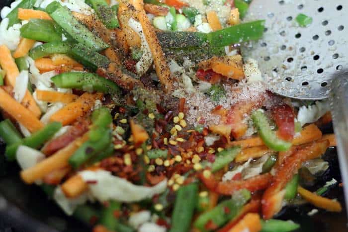 soy sauce, vegetarian oyster sauce, salt, chili flakes and sugar added to sauteed vegetables