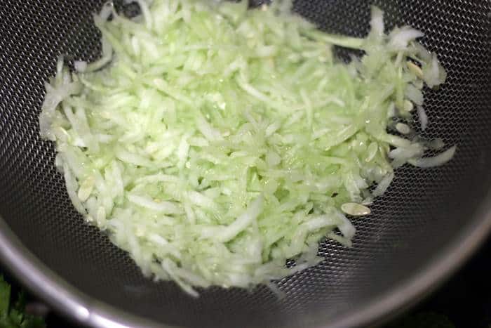 draining excess water from grated cucumber