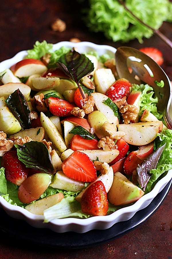 closeup shot of fresh apple strawberry walnut salad