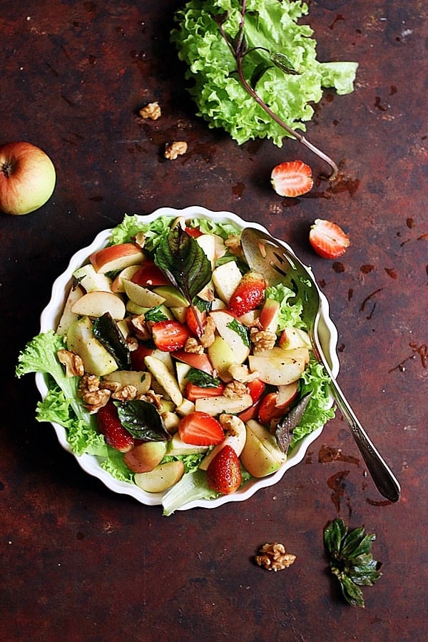 easy apple walnut salad served in a ceramic bowl.