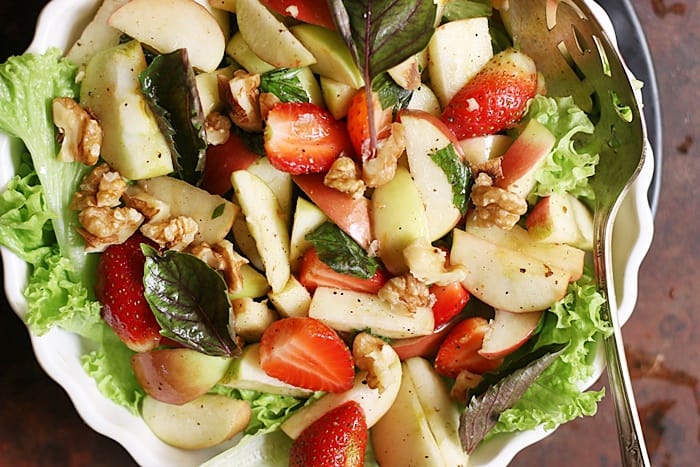 walnut apple salad served over a lettuce bed.