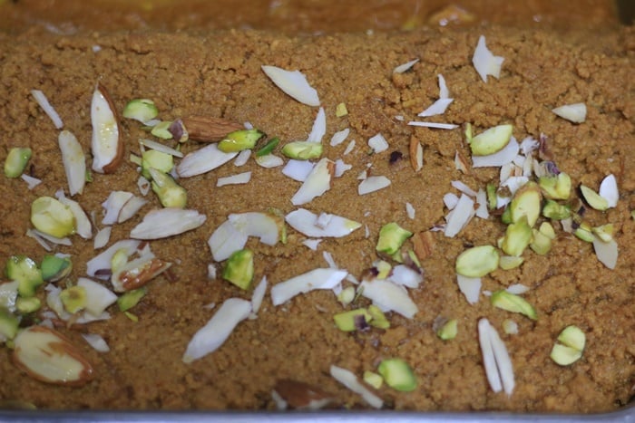 setting chickpea fudge- mohanthal in a greased pan.