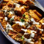 homemade tofu tikka masala curry served in steel plate with a spoon