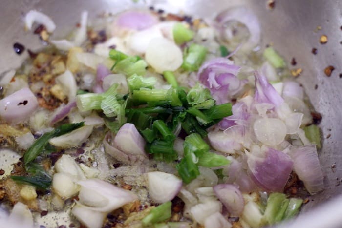 stir frying spring onions and onions