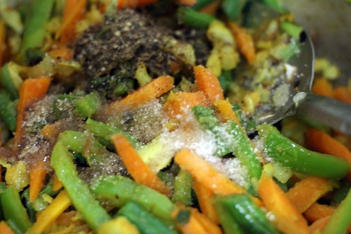 pepper and salt added to cooked vegetables