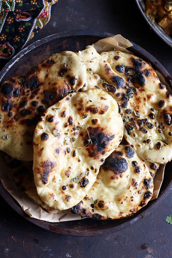 Kulcha stacked in a wooden plate