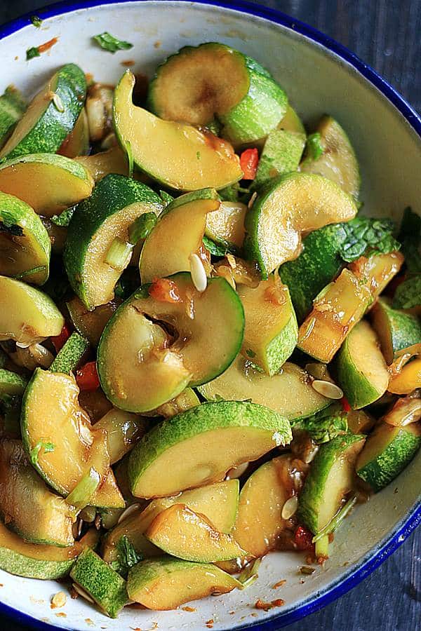 Smashed cucumber salad served in an enamel bowl