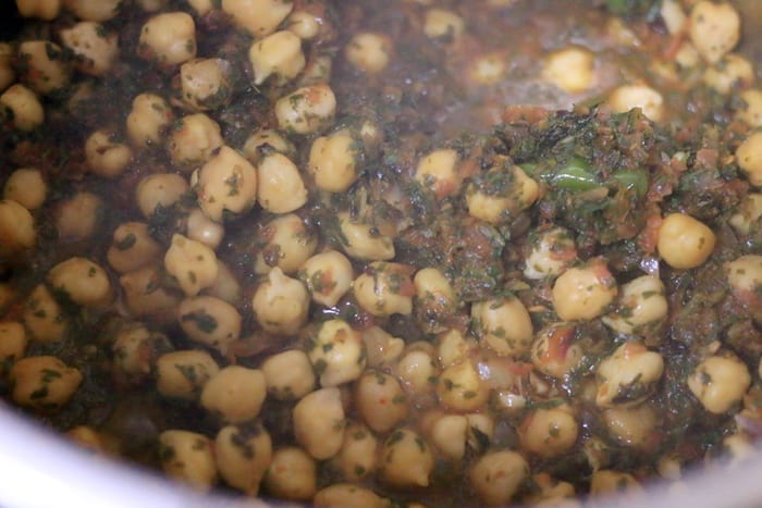 making chickpea saag curry