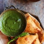 crispy samosa- vegetable samosa in a copper plate with green chutney