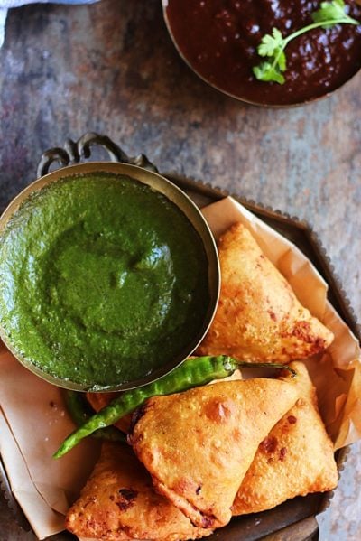 crispy samosa- vegetable samosa in a copper plate with green chutney