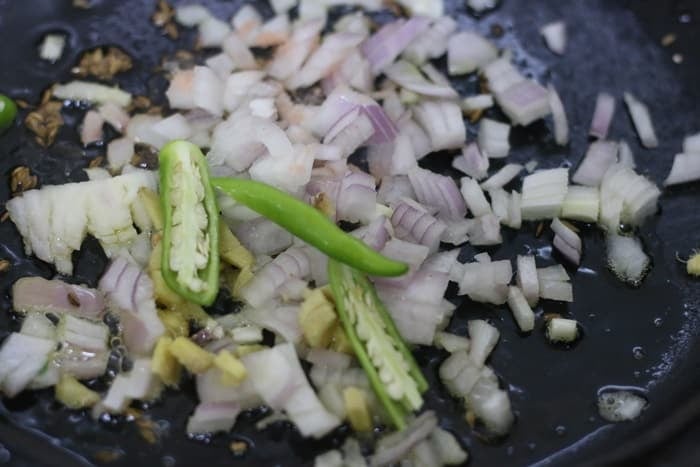 sautéing onions, green chilies and ginger in oil