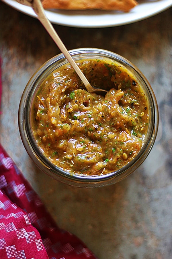 roasted tomato salsa in a jar with a spoon.