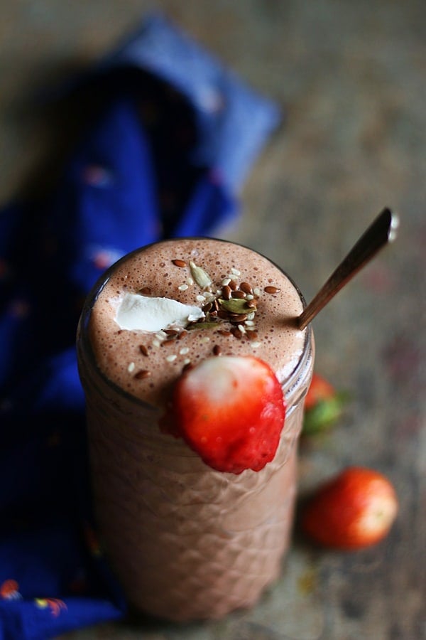 strawberry chocolate smoothie served with coconut cream and seeds