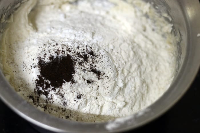 adding flour mixture to creamed butter sugar mixture