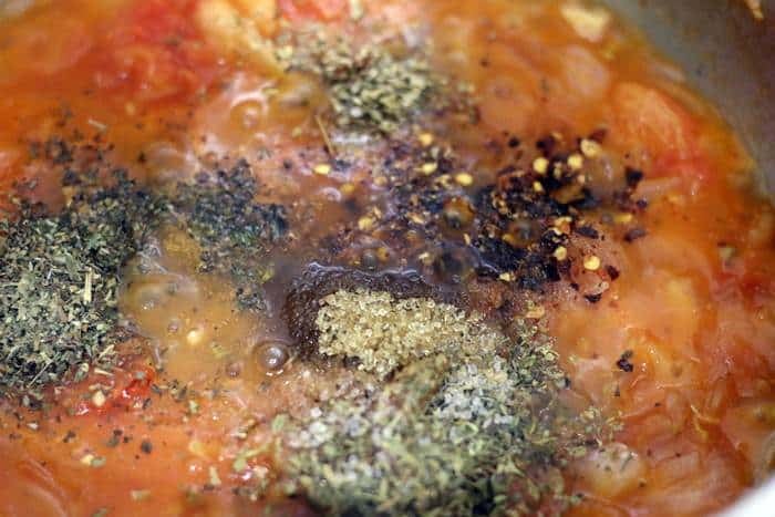 herbs and seasonings added to crushed tomatoes for making sauce.