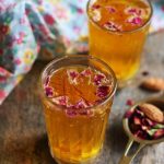 homemade kahwa served in a small glass with more tea in background