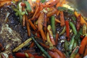 sauce tossed in vegetables over high heat