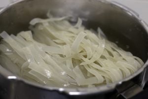 raw wide rice noodles ready to be cooked