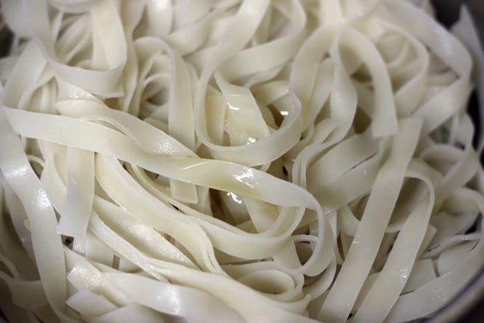 cooked and drained rice noodles tossed with few drops of oil