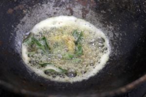 sauteing cumin seeds ginger and curry leaves in mustard oil,